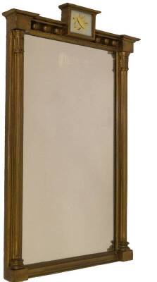 A Regency gilt wood pier glass, with a verre eglomise trophy to the beaded pediment, having reeded supports and moulded slip, 85cm x 53cm.