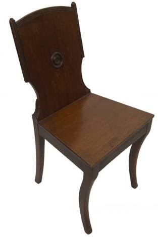A Regency mahogany hall chair, with reeded and roundel back, plain seat and sabre forelegs, 43cm W.