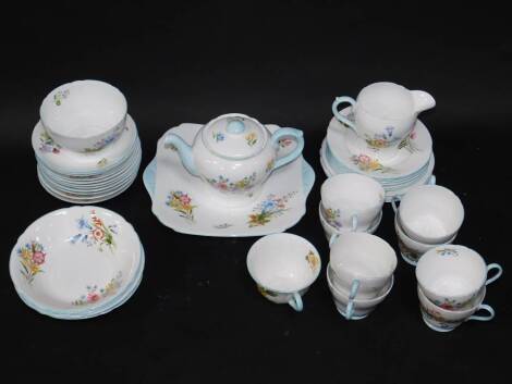 A Shelley porcelain part tea service decorated in the Wild Flowers pattern, no.13668, comprising tea pot, cream pot, sugar bowl, bread plate, eight cups, eleven saucers, nineteen plates in two sizes, and four fruit bowls, and a further Shelley porcelain 