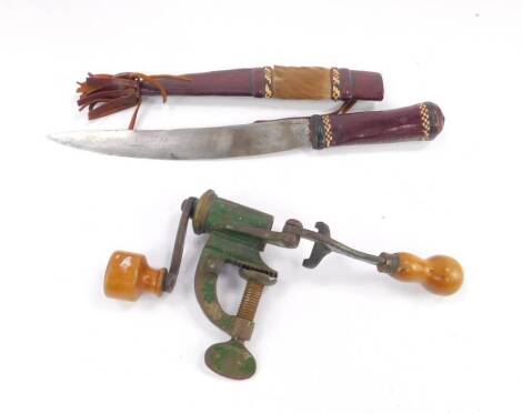 A tribal knife, leather and hide bound, 31cm L, together with a cartridge loader. (2)