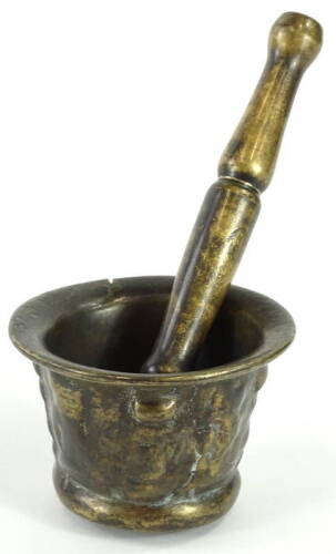 A 17thC bronze mortar, with indistinct cast decoration, 7cm H, 10cm dia. and an associated pestle, 18.5cm L.