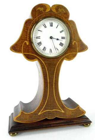 An Edwardian mahogany and marquetry mantel timepiece, modelled in the form of a stylised tree, the white enamel dial with Roman numerals, the brass movement stamped with a lion, on gilt metal bun feet, 30cm H, 21cm W.