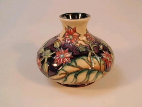 A modern Moorcroft squat globular vase with pink floral decoration