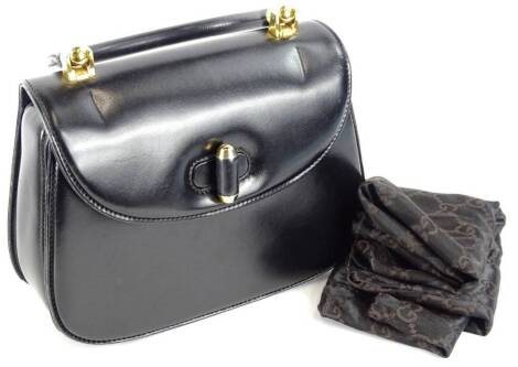 A vintage Gucci black leather top handle bag, with gold hardwear and dustbag.