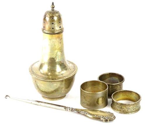 A collection of small silver, to include a sugar castor, button hook and napkin rings, 9oz gross.