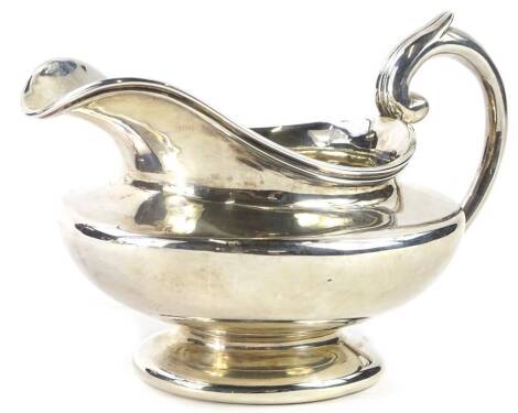 A William IV plain silver milk jug, with shaped handle and domed foot, London 1834, 7¾oz