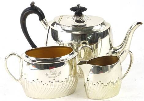 A Victorian silver three piece tea set, with part fluted decoration, ebonised knop and handle, Sheffield 1891, 32oz gross.