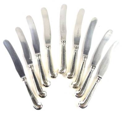 A set of nine Victorian silver pistol handled table knives, the stainless blades engraved Goldsmiths and Silversmiths company, Regent Street, the handles hallmarked for 1871.