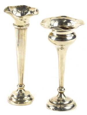 Two similar early 20thC silver bud vases, each with a weighted base, one hallmarked for Chester 1919.