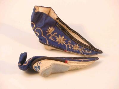 A pair of Chinese silk shoes with gilt flowerhead embroidery