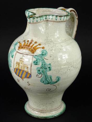 An Italian tin glazed ewer or jug, decorated with a crest and dated 1625, 35cm H.