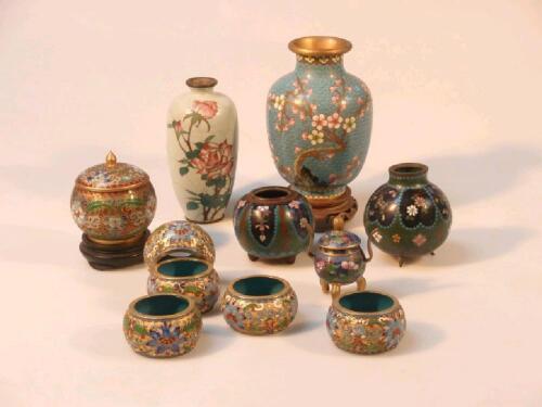 A small collection of cloisonne vases and napkin rings