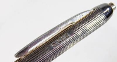 An Elizabeth II silver ball point pen, with engine turned body and plain clip, Birmingham 1956, 13cm W, in associated case. - 2