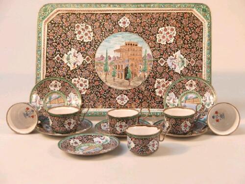 A Middle Eastern enamelled coffee set of six cups and saucers and matching tray