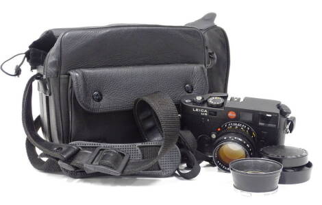 A Leica M6 camera body, fitted with a Leitz Sh-lux 1:1.4/50 lens, with a bag, etc.