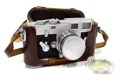 A vintage Leica Ernst Leitz camera, M3-857092, in brown leather case with Summicron f=5cm1:2 lens, 9cm H.