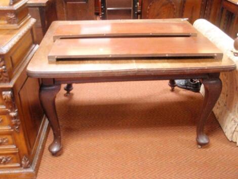 A mahogany wind-out dining table