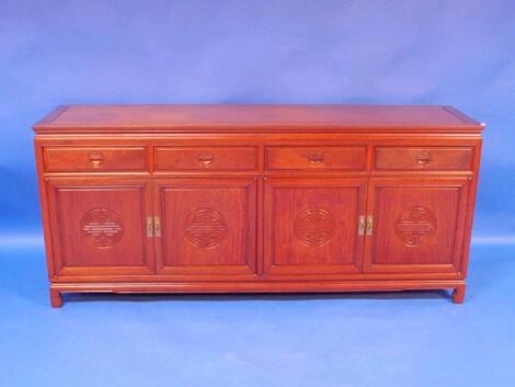 A Chinese cherry wood circular dining table