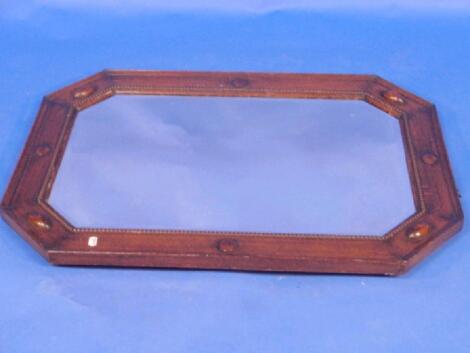 A bevelled oak framed octagonal wall mirror