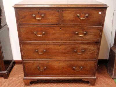 A George III mahogany chest of two short and three long graduated drawers