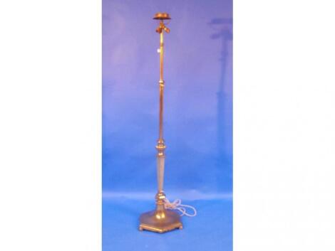 An adjustable brass floor lamp