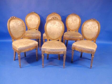 A set of six 19thC French gilt wood dining chairs with oval ribbon carved