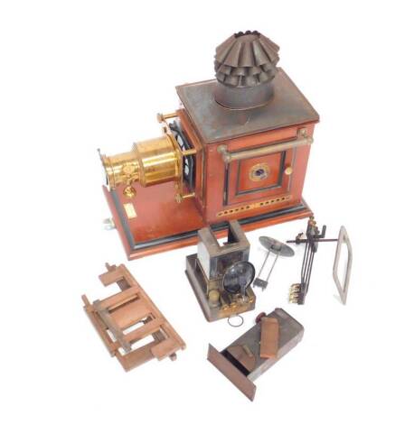 A Victorian mahogany and brass Optimus "Magic Lantern" by Perken Son & Co Ltd Hatton Garden London, with an improved stocks wrench lamp, patent no.705, 48cm H, 26cm W, 48cm D.