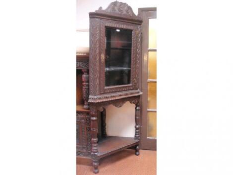 A Georgian oak corner cabinet