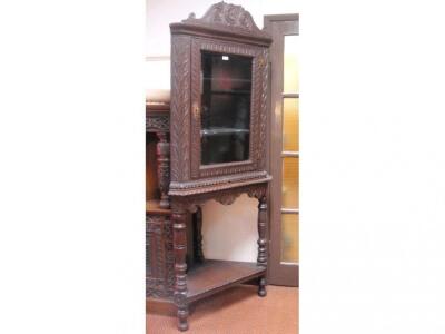 A Georgian oak corner cabinet