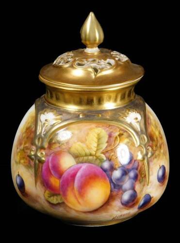 A 20thC Royal Worcester porcelain potpourri jar and cover, by Nigel Creed, handpainted with autumnal fruits to include peaches and grapes, with pierced lid, with gilt highlights, on a circular foot, no.175, signed, with printed marks beneath, 13cm H.