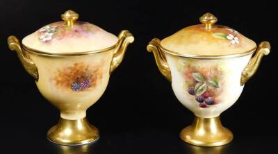 A pair of 20thC Coalport porcelain lidded vases, by Richard Budd, each with compressed circular lids with shaped knops, flanked by scroll handles, on inverted stems and circular feet, signed, with printed marks beneath, 20cm H. (2) - 2