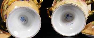 A pair of 20thC Coalport porcelain lidded vases, by Richard Budd, each with compressed circular lids with shaped knops, flanked by scroll handles, on inverted stems and circular feet, signed, with printed marks beneath, 20cm H. (2) - 4