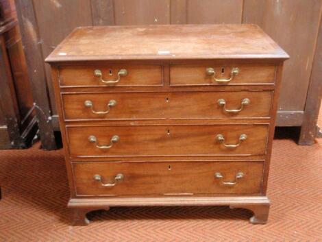 A George III cross banded mahogany chest of two short and three long graduated drawers