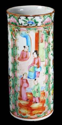 A 19thC Cantonese famille rose brush pot, the tapering cylindrical body set with panels of figures in an interior setting and further panels of birds and insects, predominately in pink, green and blue, 25.5cm H.