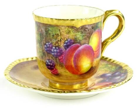 A Royal Worcester porcelain cup and saucer, decorated with fruit by Freeman, printed mark in black to underside, in presentation box.