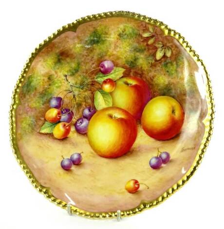 A Royal Worcester porcelain plate, decorated with fruit by Freeman, within a gilt border, printed marks in black to underside, 26cm dia.