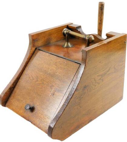 An early 20thC oak coal box, of rectangular form, with cylindrical brass handle and shovel 34cm W.