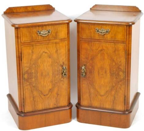 A pair of Edwardian walnut D end pot cupboards, each with moulded rounded tops, with a single frieze drawer and cupboard beneath, 76cm H, 41cm W, 40cm D.