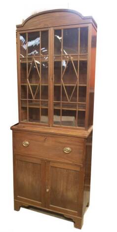 A Regency mahogany cabinet secretaire bookcase, with reeded arch top, over two lozenge astragal glazed doors, the secretaire door revealing pigeon holes and drawers, over two moulded panel doors and bracket feet, 234cm H, 90cm W, 50cm D.