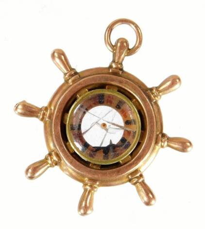 A 9ct gold ship's wheel charm, 4cm W, 3.5g all in.