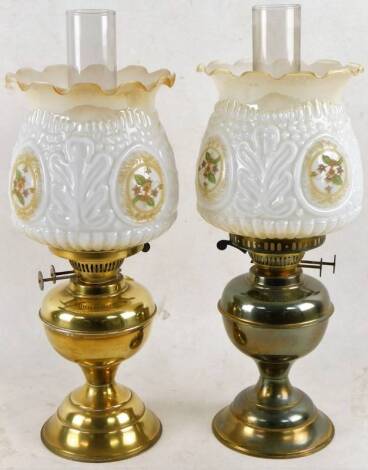 Two early 20thC brass oil lamps, of inverted form with fixed brass reservoir, associated shades and funnels, 46cm H. (2)