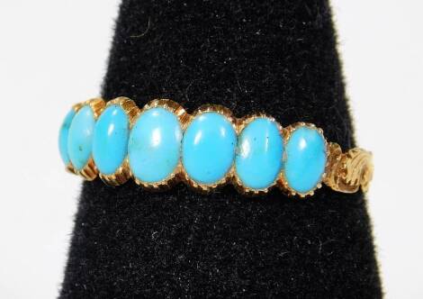 A Victorian memorial ring, set with seven oval turquoise stones, on a yellow metal band, unmarked, ring size N, 2g all in.