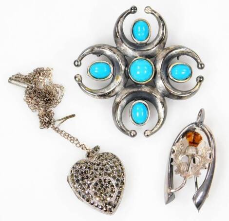 Three items of costume jewellery, to include a silver wishbone brooch with orange paste stone, a silver heart shaped locket on silver plated chain and a turquoise set pewter brooch. (3)