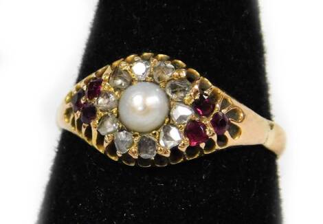 A ruby diamond and pearl dress ring, the cluster design with central pearl surrounded by rough cut diamonds and three garnets to each shoulder, each in claw setting, yellow metal, unmarked, ring size P½, 2.7g all in.