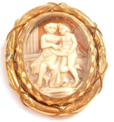 A Victorian shell cameo brooch, carved with two Roman figures in discussion, aside a column, set in yellow metal.