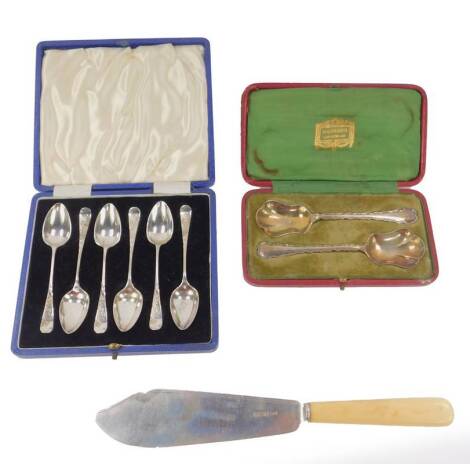 A George V silver fish knife server, with ivory handle, Sheffield 1925, a pair of George V silver jam spoons, for Harrods London, cased, Sheffield 1912, and six plated coffee spoons, cased.