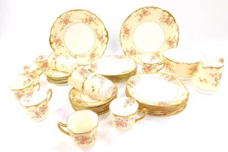 A late 19thC Staffordshire porcelain tea service, printed and painted with flowers against a yellow ground, gilt heightened, comprising a pair of bread plates, cream jug, sugar bowl, eleven tea cups, twelve saucers and tea plates.