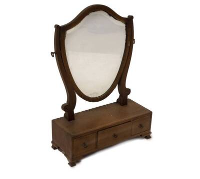 A 19thC mahogany dressing table mirror, with shield shape bevel plate, three drawer base with chevron stringing, brass loop handles, on ogee bracket feet, 65cm H, 44.5cm W, 18cm D.