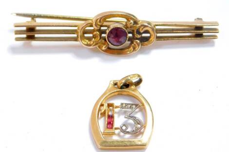 A ruby and diamond set No 13 pendant, set in Continental yellow metal, together with a Victorian amethyst brooch, set in yellow metal, 5.0g. (AF)