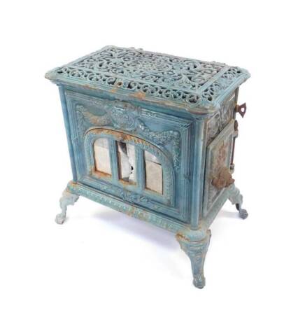 Le Select - A late 19thC / early 20thC French teal enamel log burning stove by Poele a Bois, Pardon de Paris, the pierced and hinged top having a shallow tray, the body cast with reeded ribbon framing, garland drops and arched central door surmounted with